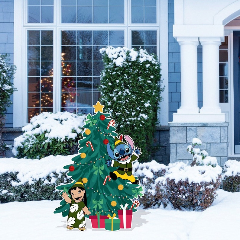 May include: A Christmas tree decorated with ornaments, candy canes, and lights. Stitch and Lilo are standing in front of the tree. Stitch is dressed as an elf and Lilo is wearing a hula skirt.