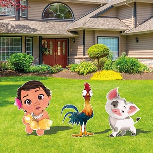 May include: Three decorative yard signs featuring a cartoon toddler with a pink flower in their hair, a colorful rooster with large eyes, and a small white pig with black spots, all standing on a green lawn in front of a residential house.