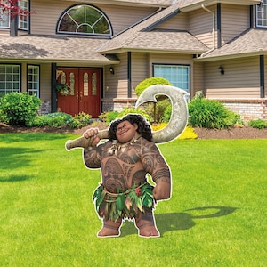 May include: A large, die-cut yard sign featuring a cartoon character with dark curly hair, extensive brown skin tattoos, and a green leaf skirt. The character is smiling and holding a large, textured, light-colored hook over their shoulder.