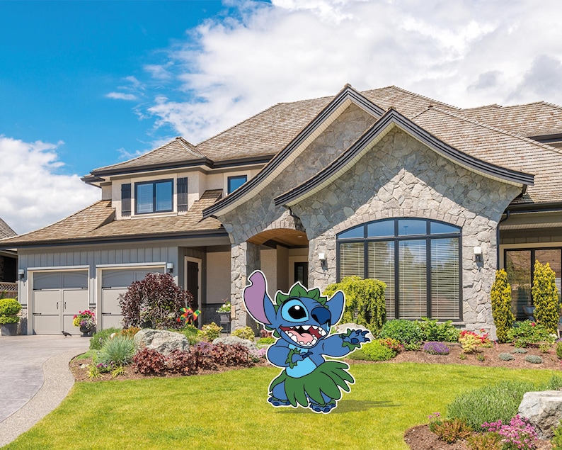 May include: A blue cartoon character with large ears, a green grass skirt, and a lei, stands on a green lawn in front of a large house with a stone facade. The character is smiling and waving, with a blue sky and clouds in the background.