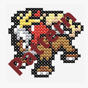 Puede incluir: Patrón de punto de cruz con un personaje de dibujos animados con un sombrero rojo, pelaje marrón y una camisa a rayas amarillas y blancas. El personaje sostiene un bastón de caramelo rojo y blanco.