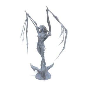 May include: A gray 3D printed figurine of a female figure with wings. The figure is standing on a base with a textured surface. The figure has a detailed design and is posed with wings outstretched.
