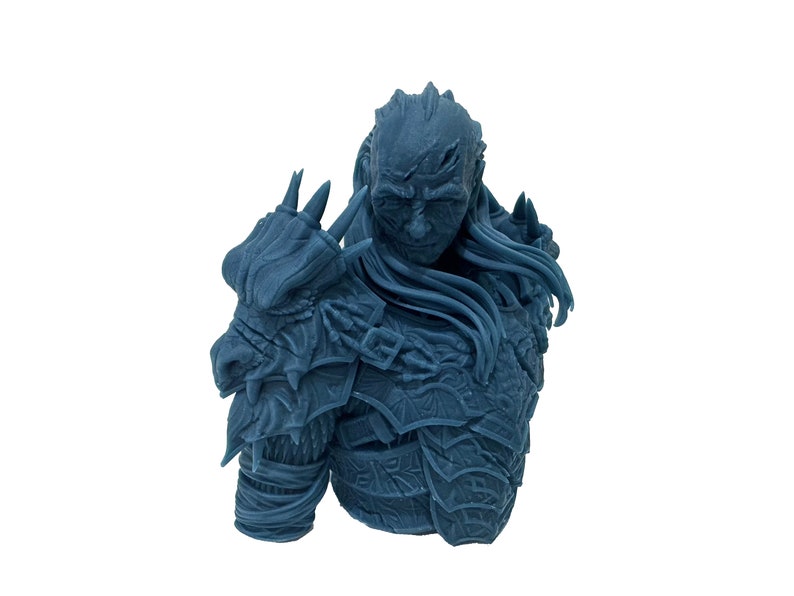 May include: A blue 3D printed bust of a warrior wearing armor with a dragon motif. The warrior has a long beard and a fierce expression.