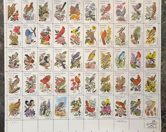 May include: A sheet of 50 US postage stamps featuring a bird from each state. The stamps are arranged in a grid of 6 rows and 7 columns. Each stamp has a different bird and the state name and abbreviation. The stamps are all in mint condition.