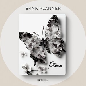 Puede incluir: Una agenda e-ink blanca con un diseño de mariposa en blanco y negro y la palabra "Planner" escrita en cursiva. La mariposa está compuesta por pequeñas flores blancas y tiene un efecto 3D.