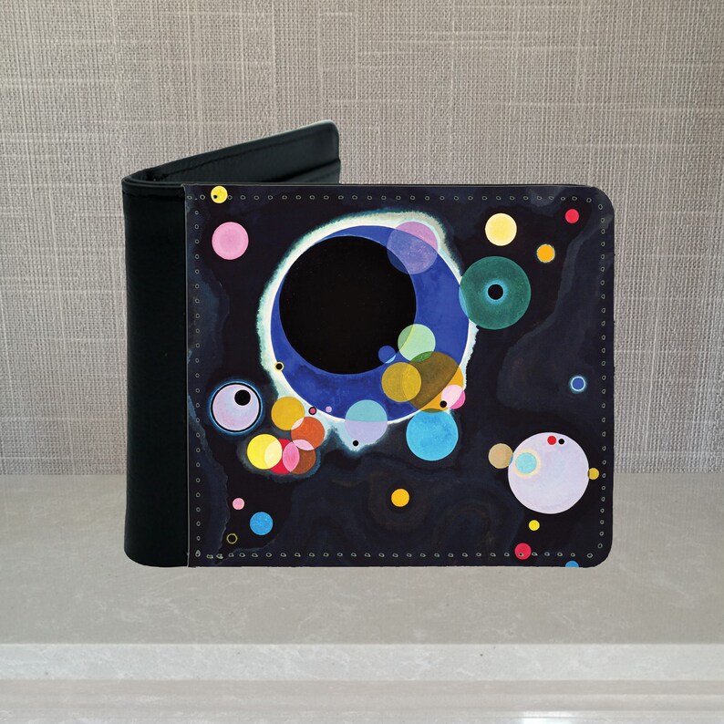 May include: A black leather wallet with a colorful abstract design featuring circles and a black background. The design is reminiscent of a painting by Wassily Kandinsky.