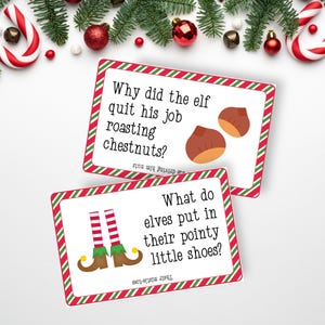 May include: Two rectangular white cards with red and green diagonal striped borders. The top card features the text Why did the elf quit his job roasting chestnuts? with an illustration of two brown chestnuts. The bottom card shows elf legs.