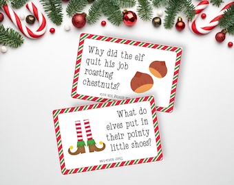 May include: Two rectangular white cards with red and green diagonal striped borders. The top card features the text Why did the elf quit his job roasting chestnuts? with an illustration of two brown chestnuts. The bottom card shows elf legs.