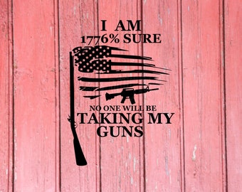 May include: Black graphic on a red wooden background. The graphic depicts a stylized American flag with a rifle and the text: "I AM 1776% SURE NO ONE WILL BE TAKING MY GUNS."