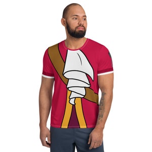 May include: A red, white, and brown t-shirt with a cartoon image of a character wearing a white ruffled collar and a brown sash.
