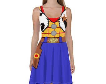 May include: A blue and yellow sleeveless dress with a red and white cowboy shirt design. The dress has a brown belt with a gold buckle and a brown holster with a yellow star on the side.