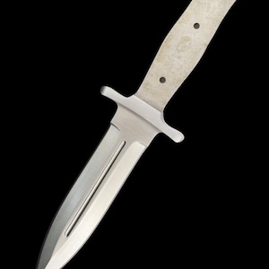 May include: A silver knife with a long, pointed blade and a plain, silver handle. The handle has three small holes.