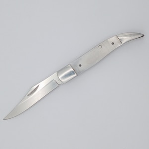 May include: A silver pocket knife with a curved blade and a simple design.