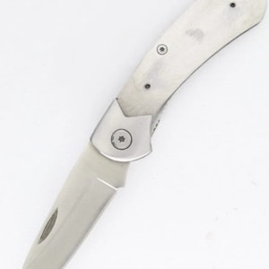 May include: A silver pocket knife with a partially open blade. The knife has a simple design with a rounded handle and a single screw visible on the handle.