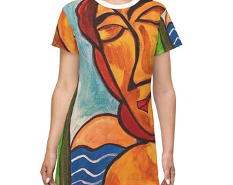 May include: A short-sleeved dress with a colorful abstract painting of a face. The painting features shades of orange, red, blue, green, and white.