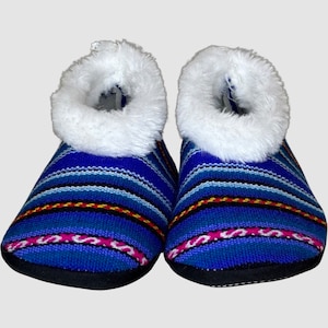 May include: A pair of blue and white striped slippers with white faux fur trim. The slippers have a black rubber sole.