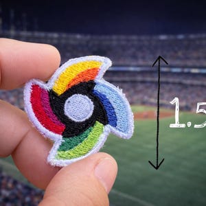 May include: A colorful embroidered patch in a spiral design, featuring a spectrum of colors including red, orange, yellow, green, blue, and black. The patch is approximately 1.5 inches in height. The design is set against a blurred stadium background.