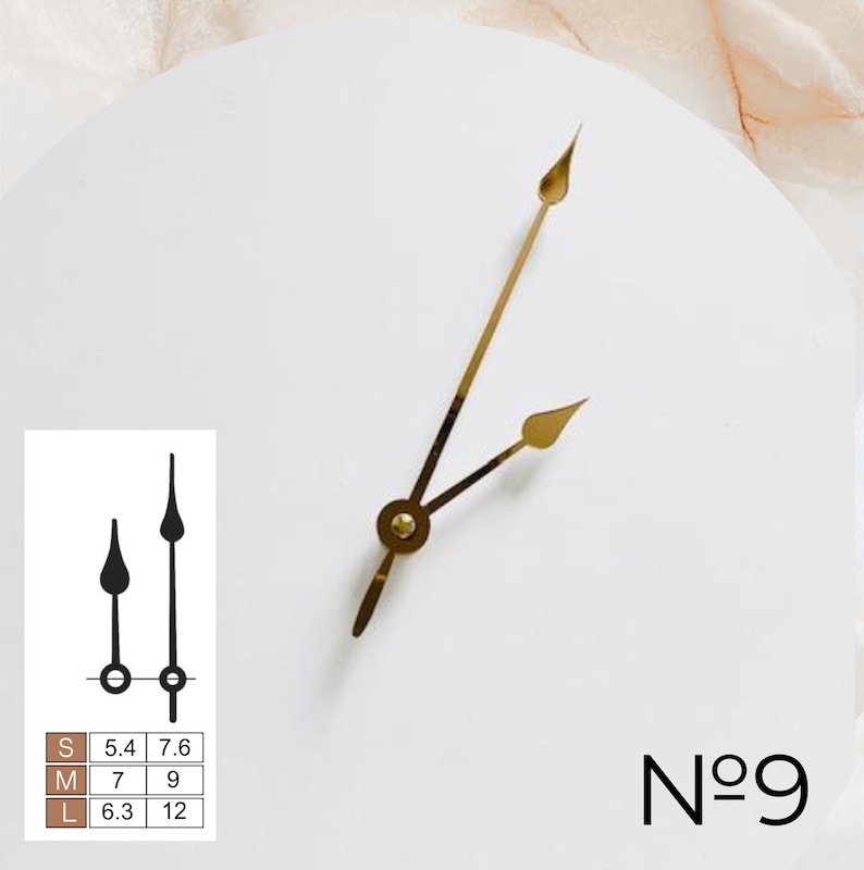 May include: A white clock face with gold hour and minute hands. The clock face has the number "N&deg;9" printed on it.