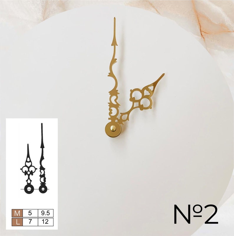 May include: Gold-colored clock hands with ornate designs, including a minute hand with an arrow-like tip and an hour hand with a decorative end. A smaller black pair of hands is shown below, with size details. The number "No 2" is printed in black.