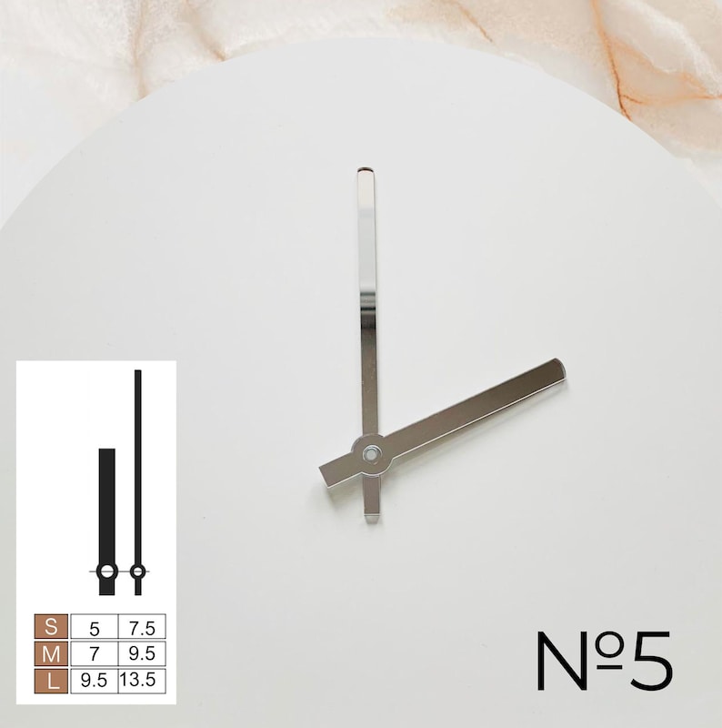 May include: White clock face with silver hands, displaying the time. The number "5" is printed in black at the bottom right. A small chart shows clock hand sizes in inches. The clock hands are at approximately 2:25.