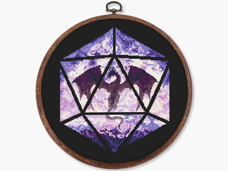 May include: Cross-stitch art in a wooden hoop. The design features a purple dragon inside a geometric shape, with a black background. The dragon is detailed with shades of purple and white.