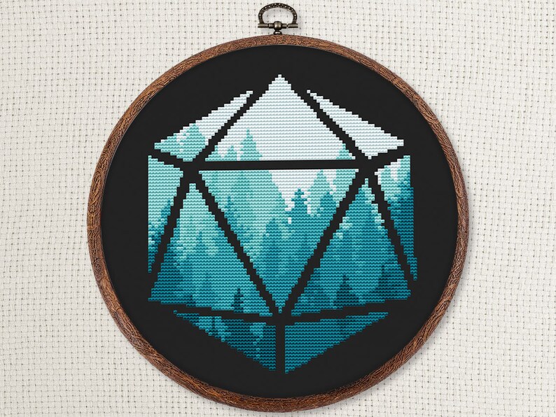 May include: A black and white cross-stitch embroidery of a forest scene inside a geometric shape resembling a twenty-sided die. The forest is depicted in shades of blue and green.