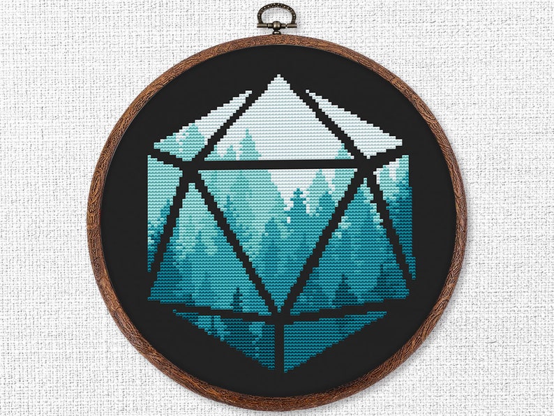 May include: A black and white cross-stitch embroidery of a forest scene inside a geometric shape resembling a twenty-sided die. The forest is depicted in shades of blue and green.