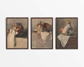 May include: Three framed watercolor paintings depicting still life arrangements of brown pottery and ceramic jugs on a table with a white cloth.