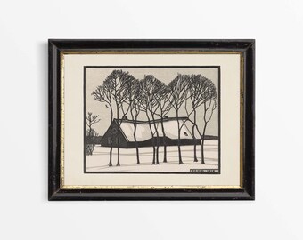 May include: A black and white woodcut print of a farmhouse in a snowy landscape. The farmhouse has a gabled roof and is surrounded by bare trees. The print is framed in a black frame with a gold inner edge. The artist's signature and date, "A.D.C. 1918", are visible in the lower right corner.