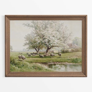 Könnte beinhalten: Ein gerahmtes Gemälde einer ländlichen Landschaft mit einem Bach, einem weißen Bauernhaus und einer Herde Schafe, die unter einem blühenden Baum auf einer Wiese grasen.