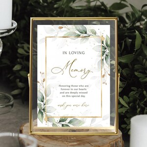 May include: A white sign with gold trim and green watercolor leaves reads "In Loving Memory" and "Honoring those who are forever in our hearts and are deeply missed on this special day. Wish you were here."
