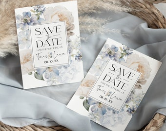 Puede incluir: Dos tarjetas de boda "Save the Date" con diseños florales en tonos azules y crema. Las tarjetas presentan texto dentro de un marco rectangular, incluyendo los nombres "Tomas & Laura" y la fecha "08.10.XX".