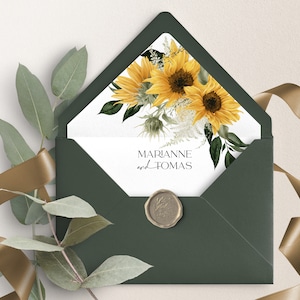 May include: A green envelope with a white card inside. The card has a watercolor illustration of sunflowers and greenery. The text on the card reads "MARIANNE and TOMAS".