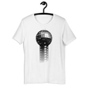 Puede incluir: Una camiseta blanca con un gráfico en blanco y negro de la Esfera, un hito en Kansas City, Missouri.