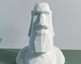 Könnte beinhalten: Eine weiße, geometrische Skulptur eines Gesichts, die an die Moai-Statuen der Osterinsel erinnert. Die Skulptur ist aus glattem, weißem Material gefertigt und hat ein schlichtes, minimalistisches Design.