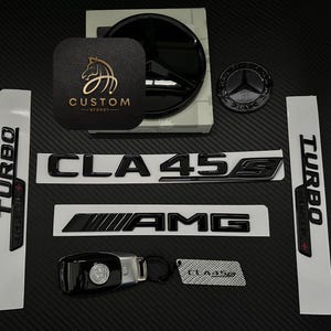 May include: Black and silver car emblems with the text "CLA 45 S" and "AMG" and "TURBO" on a black and white background.