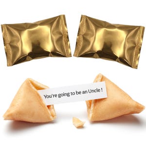 Pu&ograve; includere: Due confezioni dorate avvolte in carta stagnola e due biscotti della fortuna, uno aperto. La fortuna dice: "Diventerai zio!". I biscotti sono marroni chiari, con un pezzetto rotto.