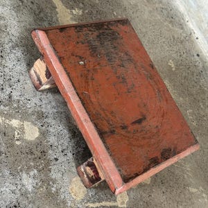 May include: A white ceramic mug with a black handle and the text "But First, Coffee" in a black, handwritten-style font. The mug is on a white surface.