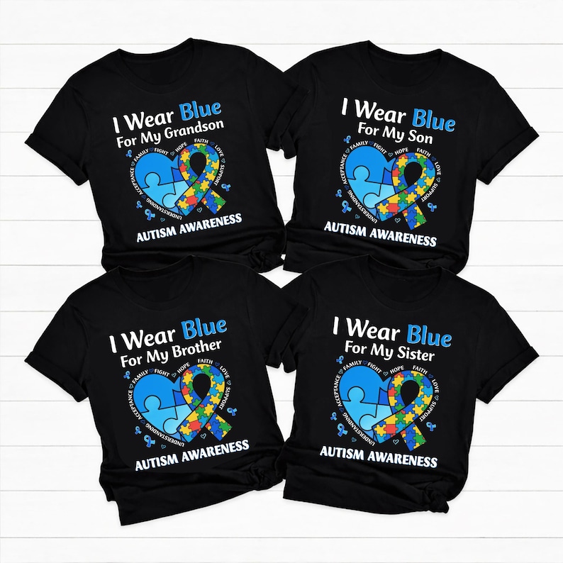 May include: Four black t-shirts with the text "I Wear Blue" and the phrases "For My Grandson", "For My Son", "For My Brother", and "For My Sister". Each shirt features a blue puzzle piece heart and a colorful ribbon, with the words "Autism Awareness".