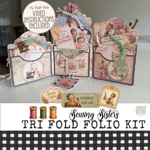 May include: A tri-fold folio kit featuring vintage-style illustrations of women sewing, floral patterns, and sewing-themed ephemera. The kit includes pockets, tags, and labels with text such as Sewing Sisters, Stitched With Love, and Handmade With Love.