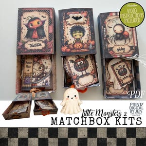 May include: Three rectangular matchbox kits featuring Halloween-themed illustrations of a vampire, a monster, and a spider. Each box contains paper ephemera with character designs. A small ghost figure sits in front, and text reads Little Monsters 2.