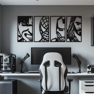 May include: A set of four black metal wall art panels featuring stylised portraits of comic book characters, including a face with a grimace, a web pattern, a robotic helmet, and a long-haired figure, mounted above a computer desk setup.