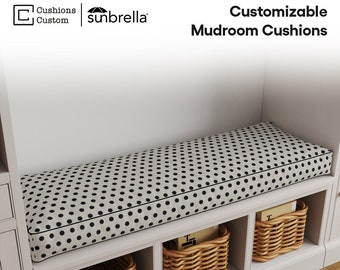 May include: A white bench with black polka dot cushions and three woven baskets underneath. The bench is in a mudroom with white walls and a wood floor. The text "Customizable Mudroom Cushions" is visible at the top of the image.