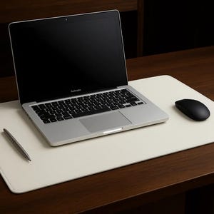 White faux leather desk mat under a laptop and mouse