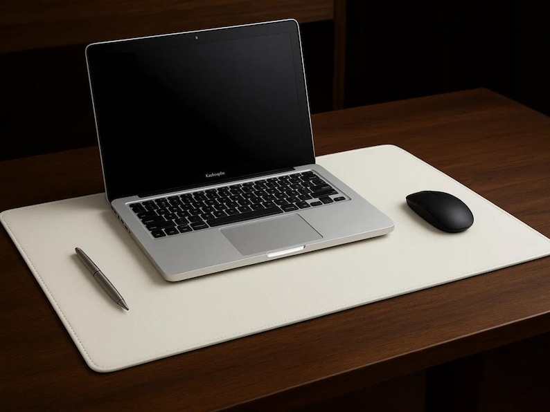 White faux leather desk mat under a laptop and mouse