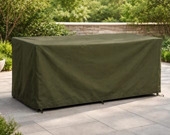 May include: An olive green rectangular outdoor furniture cover. The cover is draped over a table, with the edges reaching the ground. The cover is made of a durable, weather-resistant material, designed to protect outdoor furniture from the elements.