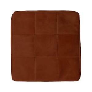 May include: A brown quilted cushion with a square shape.