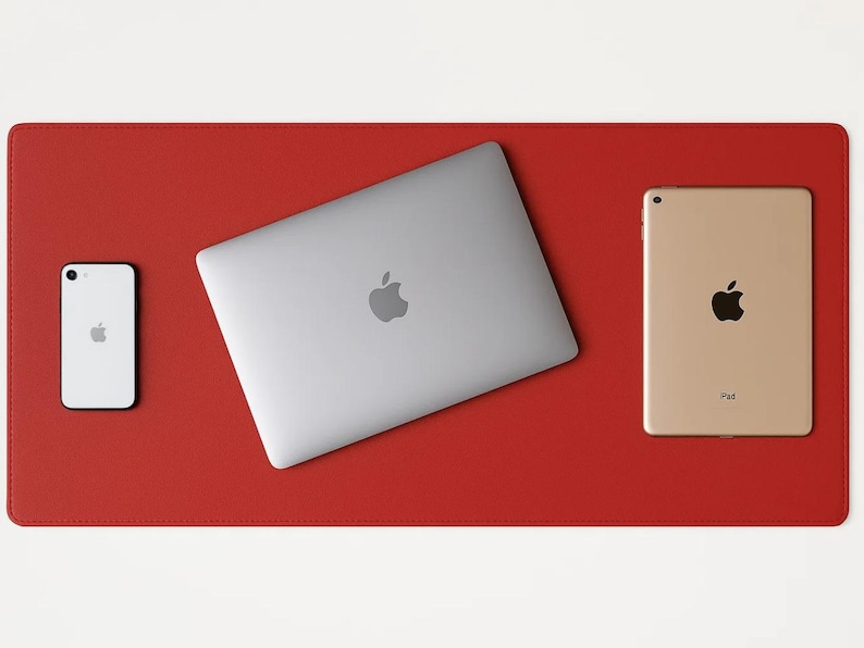 Red faux leather desk mat under a laptop and tablet