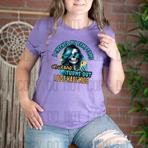 May include: Purple t-shirt with a graphic of a skeleton holding a phone and the text "I checked my symptoms on WebMD turns out I just have kids".