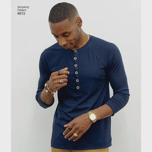 May include: A navy blue Henley shirt with long sleeves and a button-down front. The shirt is a classic design, made from a soft, comfortable fabric. The text "Simplicity Pattern 8613" is visible in the upper left corner.